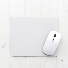 White wireless mouse on a mouse pad, top view © Ievgen Skrypko