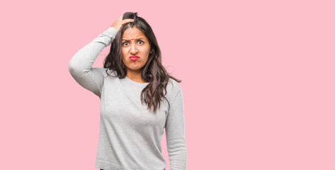 Portrait of young indian woman worried and overwhelmed, forgetful, realize something, expression of shock at having made a mistake
