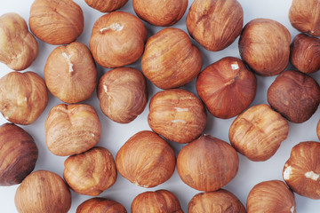 hazelnut layout on a white background, purified kernel of the nut removed from the top