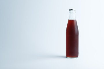 glass bottle with drink on white background