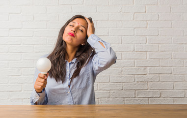 Young indian woman worried and overwhelmed, forgetful, realize something, expression of shock at...