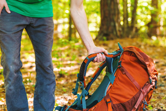 Hiker Holding His Camping Backpack In The Forest