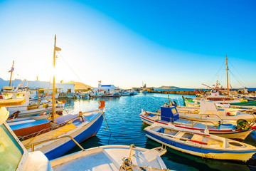 Sunshine view of turquoise bay and colorful yachts at stony berth of greek island Paros