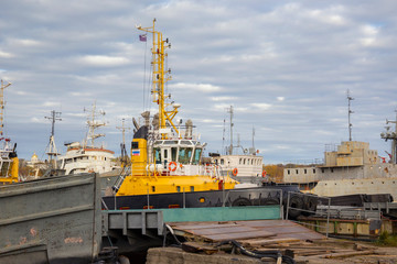 Tugboats and other marine support vessels in port.