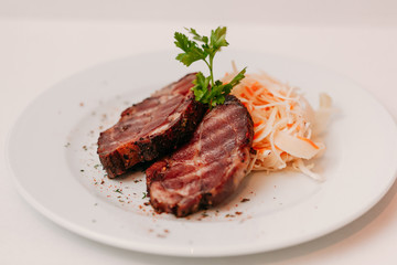 European international fusion cuisine, a beautiful dish on a white plate decorated with herbs and vegetables. a professional chef has prepared a delicious meal.