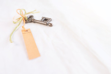 Old key with paper tag.Valentine's day concept background.