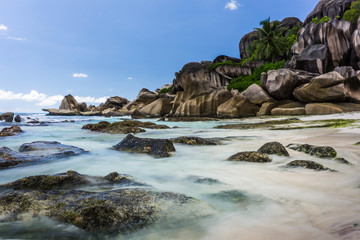 Fototapeta na wymiar Beautiful waves on a remote beach on a tropical island of Seychelles