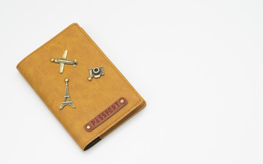 Cover on the passport isolated on white background. International leather passport cover with travel items decoration.