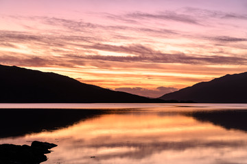 The sun setting over Loch Sunart, Ardnamurchan, on New Years Day night. Scotland. 