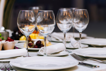 Beautifull glasses on table light white background. Party with red and white wine and holiday celebration concept.