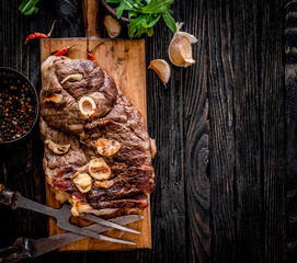 Grilled meat with garlic on a wooden board