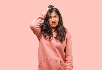 Portrait of fitness young indian woman worried and overwhelmed, forgetful, realize something,...