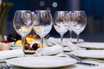 Beautifull glasses on table light white background. Party with red and white wine and holiday celebration concept.