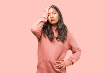 Portrait of fitness young indian woman worried and overwhelmed, forgetful, realize something,...