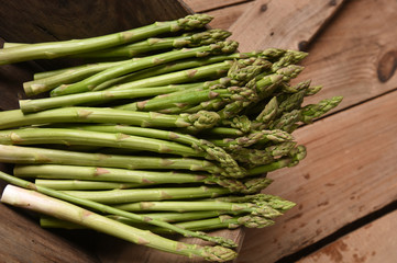 green asparagus on old board