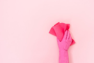Woman holding pink cleaning towel in her hands