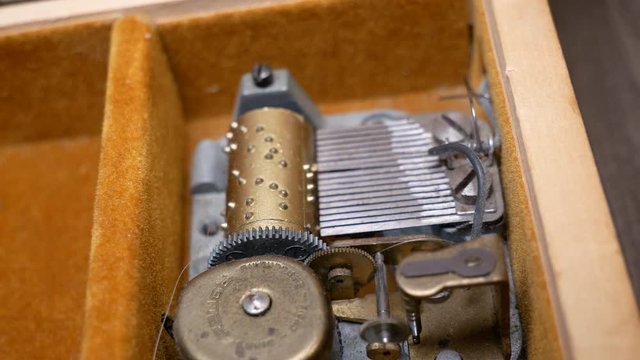 Gears and mechanical inside of an old wind up music box