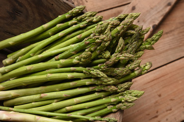 green asparagus on old board
