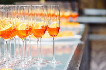 Beautifull Champagne glasses on light white background with orange. Party and holiday celebration concept