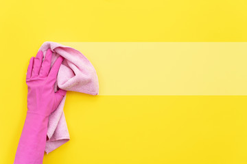 Woman holding cleaning soft pink towel in her hand