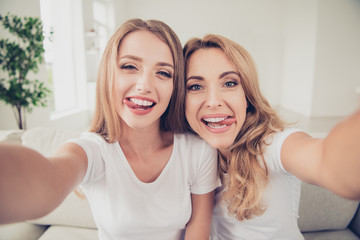 Close up photo of two people mum and teen daughter holding hands arms telephone funny tongue out of...