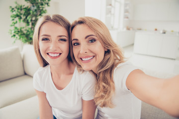 Close up photo of two people pretty mum mommy and teen daughter trendy make take selfies toothy...