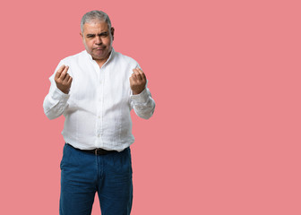 Middle aged man sad and depressed, making a gesture of need, restoring to charity, concept of...