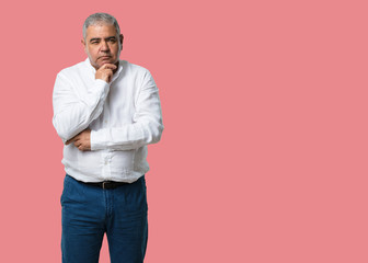 Middle aged man thinking and looking up, confused about an idea, would be trying to find a solution