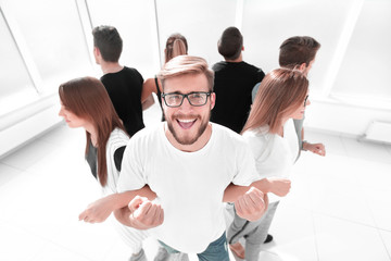 young man standing in a circle with a business team