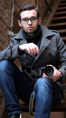 Portrait of a young promising guy photographer closeup