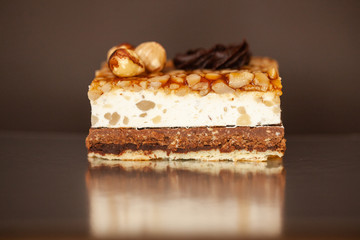A piece of chocolate cake with mint on the table, close-up