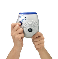 Hands shooting camera against white background. Flashing shot