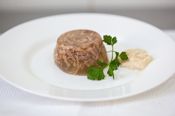 European international fusion cuisine, a beautiful dish on a white plate decorated with herbs and vegetables. a professional chef has prepared a delicious meal.