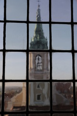 A view from the tower of the historic Gothic town hall in Torun. The baroque church of the Holy Spirit visible through the glass window. UNESCO heritage.