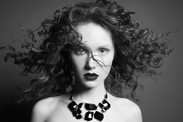 Beautiful nude woman with black jewelry. Fashion portrait