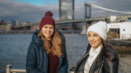 Two friends travel to New York for sightseeing at Brooklyn Bridge