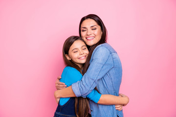 Portrait of two nice cute adorable sweet winsome lovely attractive charming cheerful cheery positive girls hugging care trust feelings isolated over pink pastel background