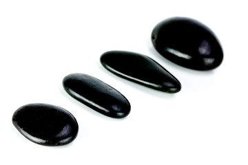 Black Stones aligned on a white background