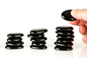 Four piles of pebbles on white background