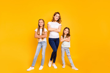 Naklejka premium Full length body size view portrait of three nice attractive slim cheerful cheery people folded arms mum mommy isolated over bright vivid shine yellow background