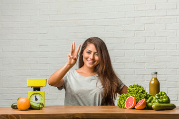 Concept of diet. Portrait of a healthy young latin woman showing number three, symbol of counting, concept of mathematics, confident and cheerful