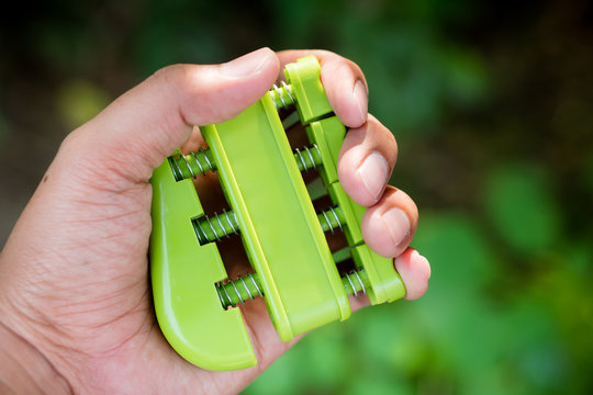 Closeup hand use finger exerciser