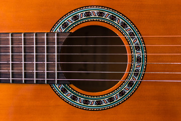 Obraz premium Classical wooden guitar strings close up