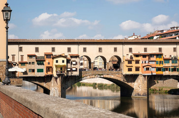 Fototapeta na wymiar Bridge over river Arno of ancient Tuscany city, Italy. Historical Florence is a UNESCO World Heritage Site