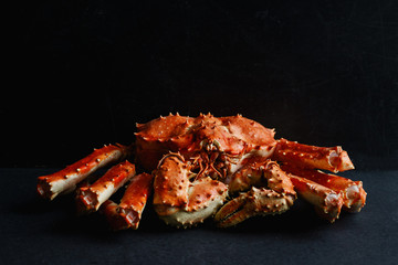Big whole alaskan crab on dark concrete background with copy space