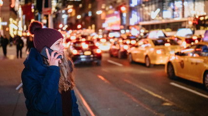 Young woman with her cell phone in the streets of New York