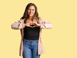 Full body young curvy woman doing a heart shape with hands