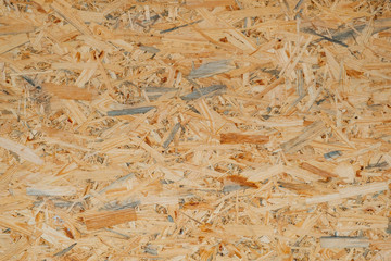 OSB pressed sawdust board,wood chips,wooden texture beckground,seamless surface