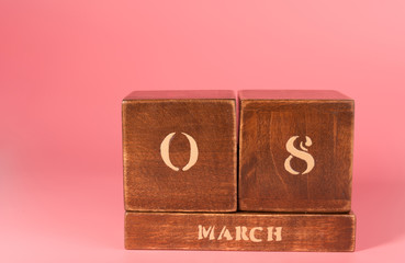 International Women’s Day vintage wooden Perpetual calendar for March 8 on a pink background