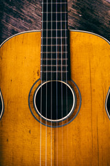 Obraz premium Closeup of wooden acoustic guitar from above.